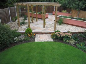 AFTER ADDING A TIMBER STRUCTURE, RAISED BEDS AND A NEW PAVED AREA GIVES A NEW LEASE OF LIFE TO THIS TIRED LAWN AIGBURTH, LIVERPOOL