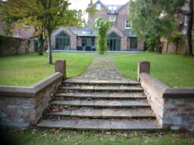 AFTER RE BUILDING THIS PATHWAY USING RECLAIMED MATERIALS  BRINGS THIS GARDEN BACK TO ITS FORMER GLORY