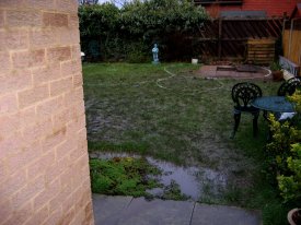 BEFORE INDIAN STONE PATIO WITH CURVED THEMED GARDEN