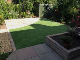 buff-patio-in-indian-sandstone-with-marshalls-tegula-traditional-walling-and-edging-artificial-grass-lawn