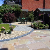 after-indian-stone-patio-with-curved-themed-garden